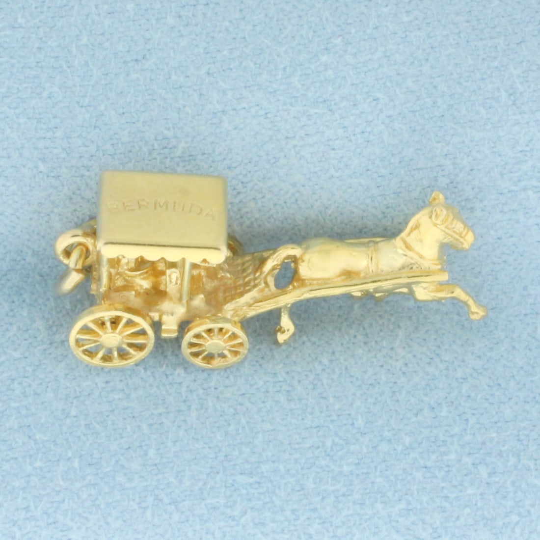Mechanical Bermuda Horse and Carriage Charm in 14k Yellow Gold: In 14k Yellow Gold. 1 inch long. 8.5mm wide (at widest). Wheels are mechanical and move. 4.3g.