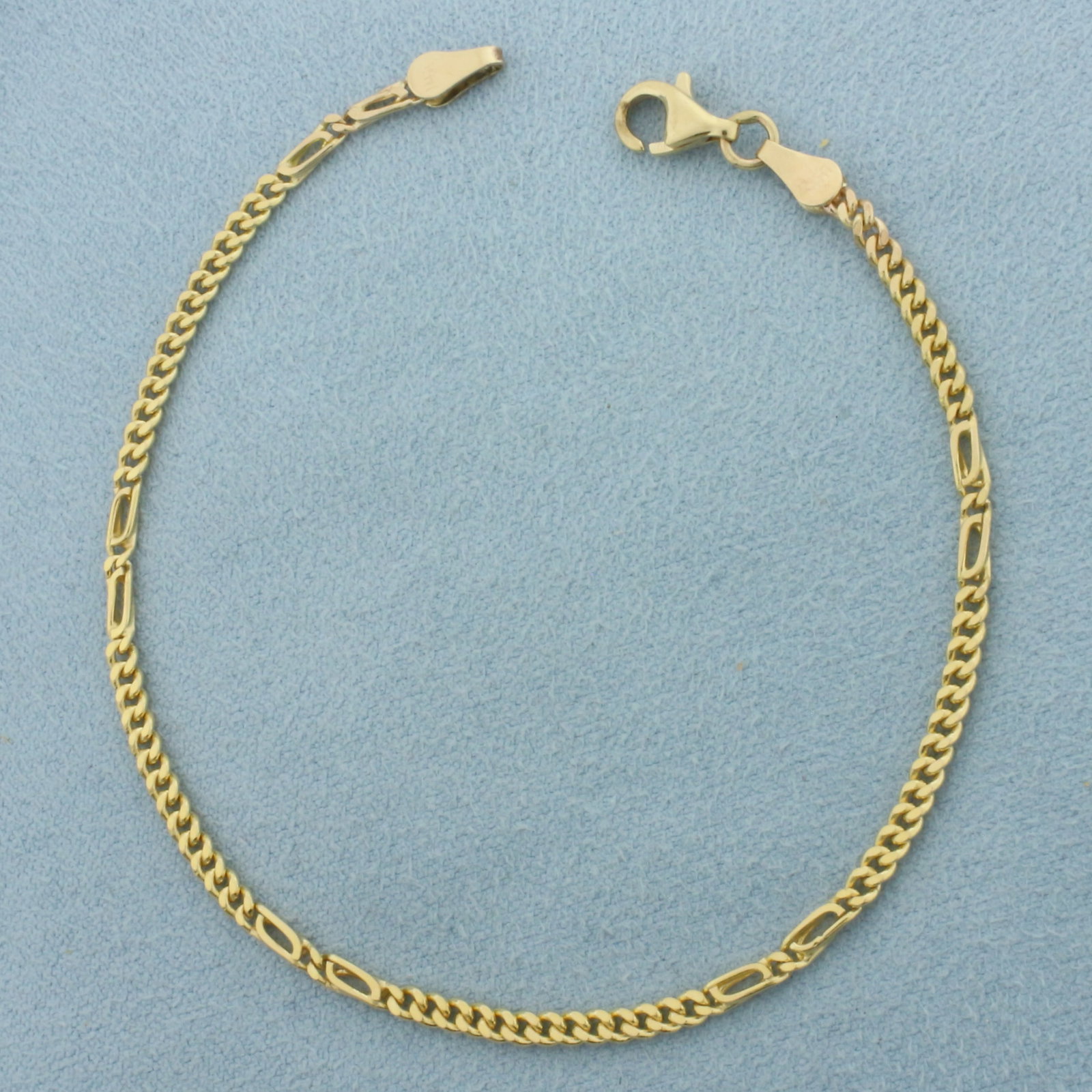 Designer Curb Link Bracelet in 14k Yellow Gold: In 14k Yellow Gold. 7 3/8 inches long. 2.3mm wide. Lobster clasp. 3.6g.