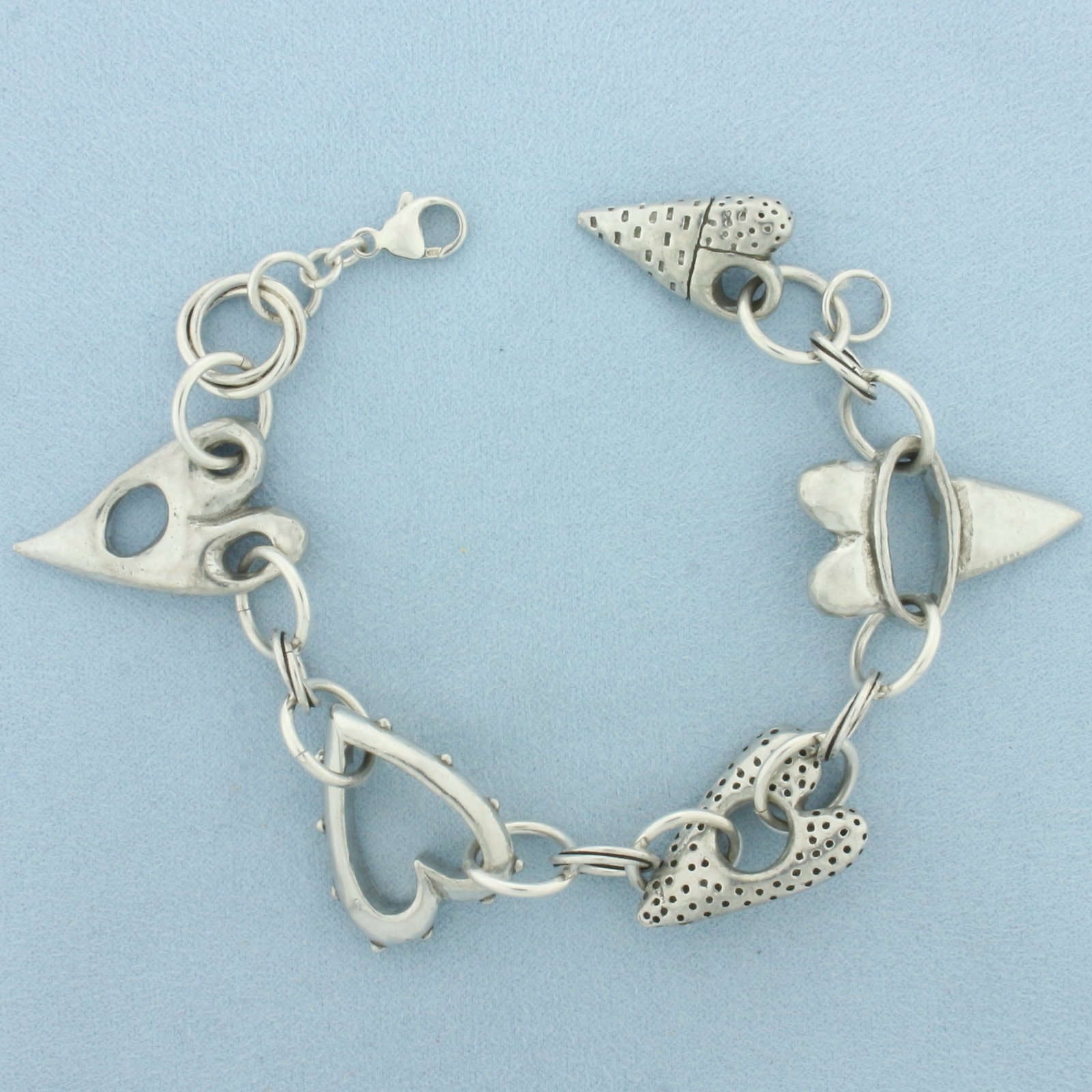 Abstract Heart Bracelet in Sterling Silver: In Sterling Silver. 8 inches long. 1 1/4 inch wide heart (at widest point). Lobster clasp.
