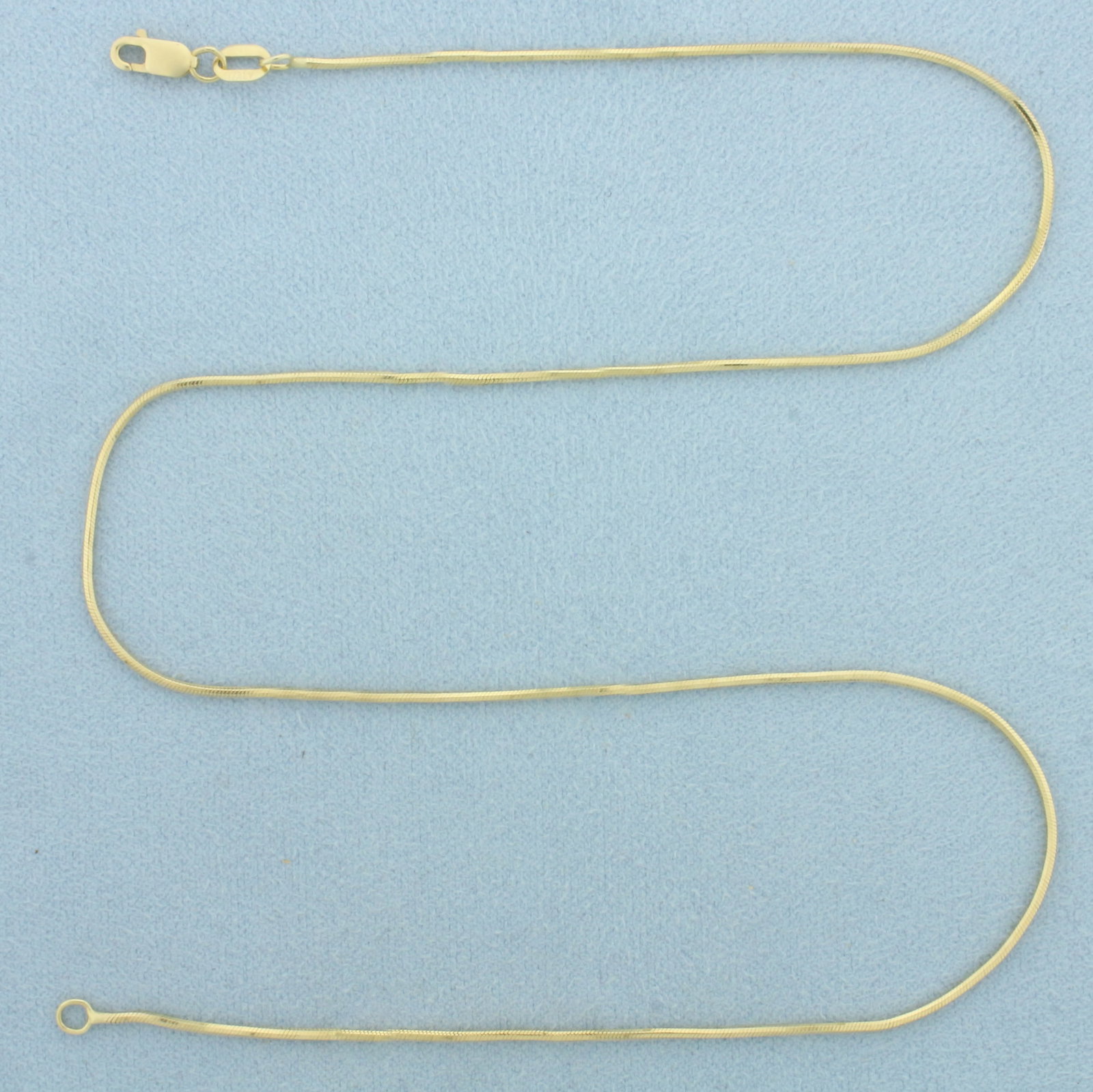 16 Inch Italian Snake Link Choker Necklace in 14k Yellow Gold: In 14k Yellow Gold. 16 inches long. 1.1mm wide. Italian made. Lobster clasp. 4.2g.
