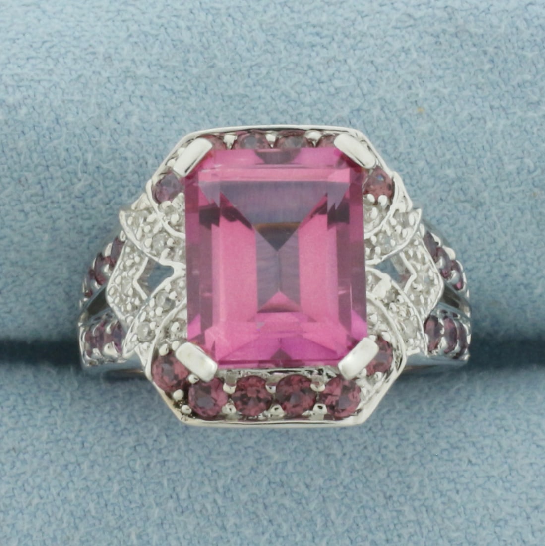 Pink Topaz and Diamond Ring in 10k White Gold: In 10k White Gold. Contains one 11x9mm high quality emerald cut natural Pink Topaz gemstone, approximately 5cts, with vibrant color and excellent clarity. Also contains twenty-four 2mm high quality na