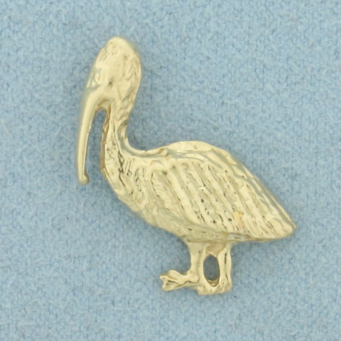 Pelican Pendant in 14k Yellow Gold: In 14k Yellow Gold. 7/8 inch long. 3/4 inch wide. 2.2g.