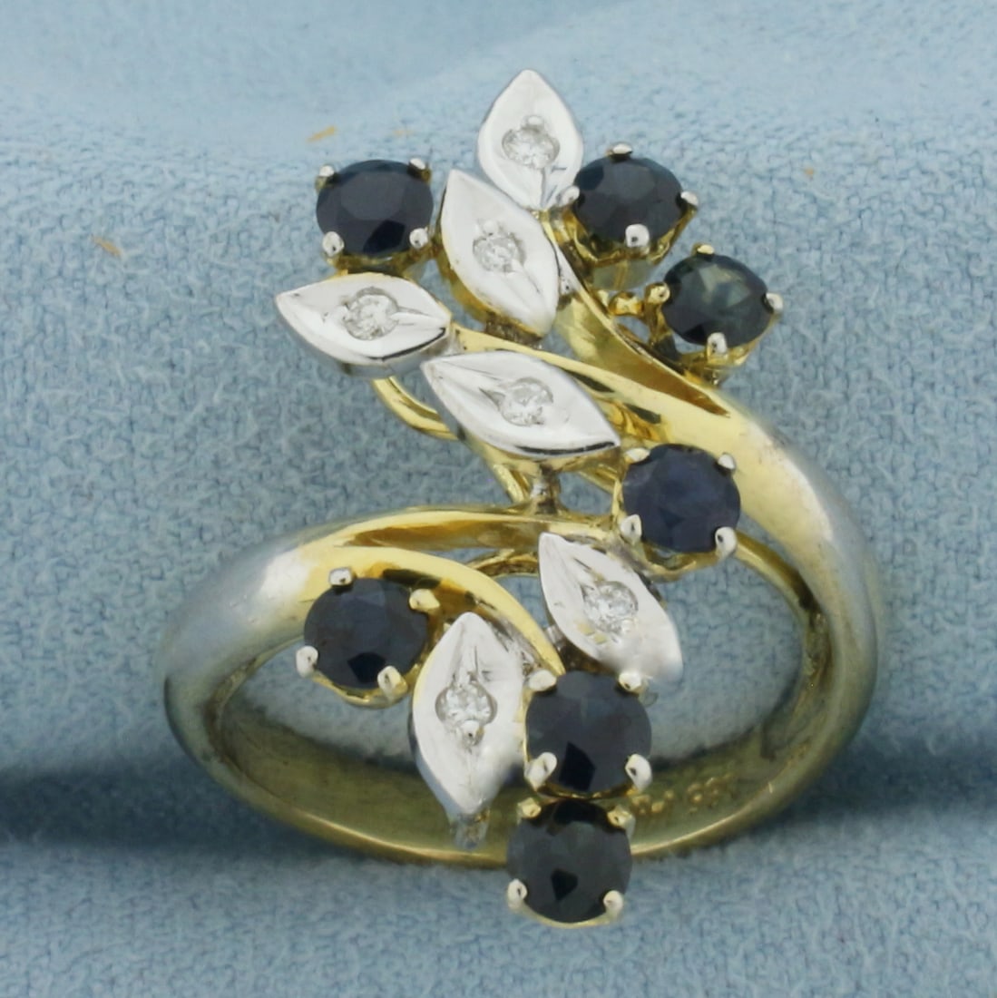 Sapphire and Diamond Branch Design Bypass Ring in 14K Yellow Gold: In 14k yellow gold. Measures 1 inch wide at top of ring. Contains 7 high quality natural 3.5mm Sapphire gemstones with intense color and excellent clarity. Accented by 6 high quality 1/2pt diamonds. S