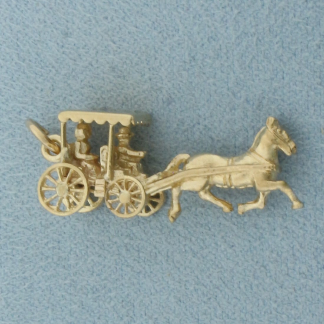Mechanical Horse and Buggy Bermuda Charm in 14k Yellow Gold: In 14k Yellow Gold. 1 1/8 inch long. 3/8 inch wide. Wheels spin. 3.7g.