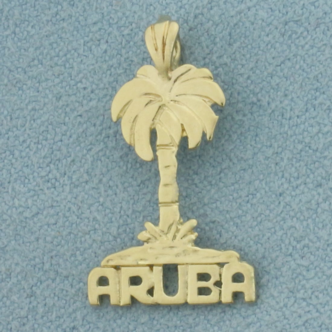 Aruba Palm Tree Pendant in 14k Yellow Gold: In 14k Yellow Gold. 1 inch long. 1/2 inch wide. 1.1g.