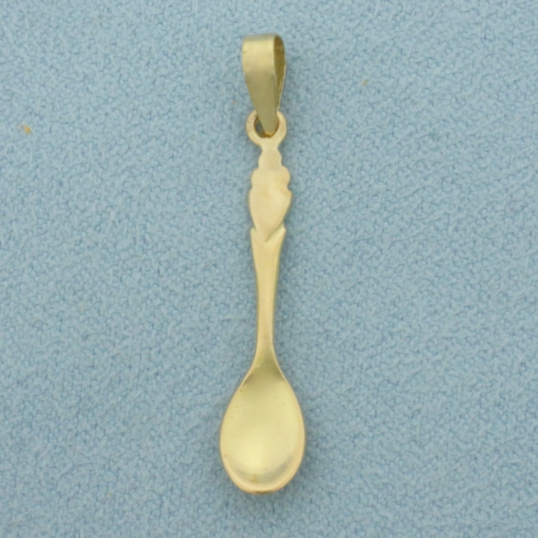 Spoon Pendant or Charm in 18k Yellow Gold: In 18k Yellow Gold. 1 1/4 inch long. 1/8 inch wide. 1.0g.