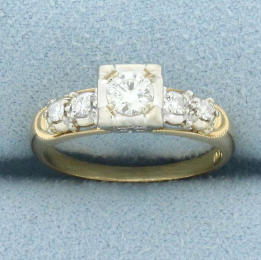 Diamond Accented Engagement Ring In 14k Yellow Gold: In 14k Yellow Gold. Contains high quality 1/4ct round brilliant diamond, SI clarity/H color. Also contains four diamonds in shank, 1/10ct TW, of similar high quality. Size 6. 2.9g.