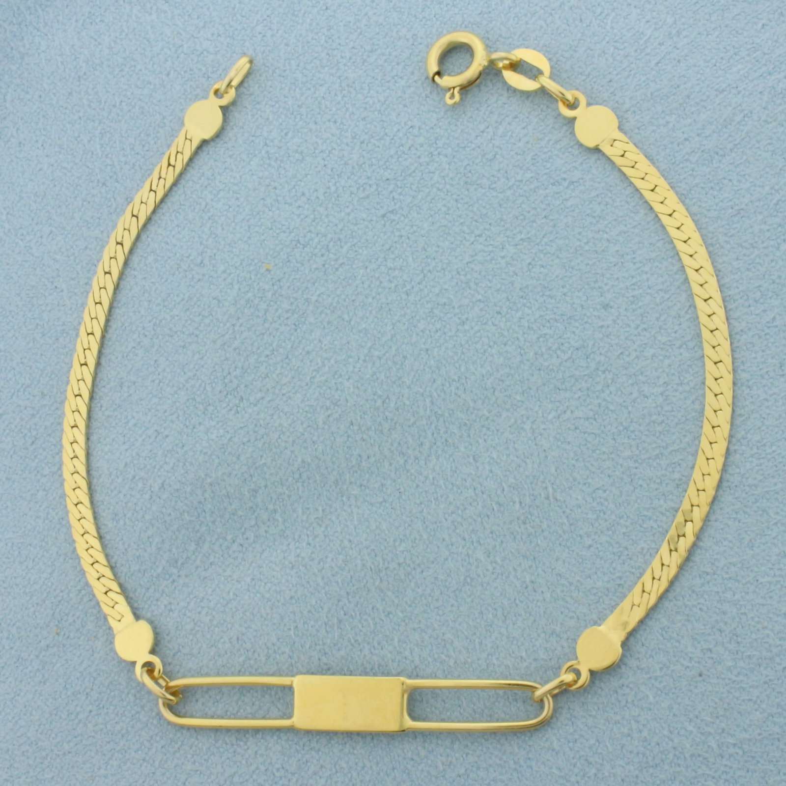 Italian Herringbone ID Bracelet in 14k Yellow Gold: In 14k Yellow Gold. 7 1/8 inches long. 5mm wide. Italian made. Can engrave initials on ID plate. Spring clasp. 3.2g.