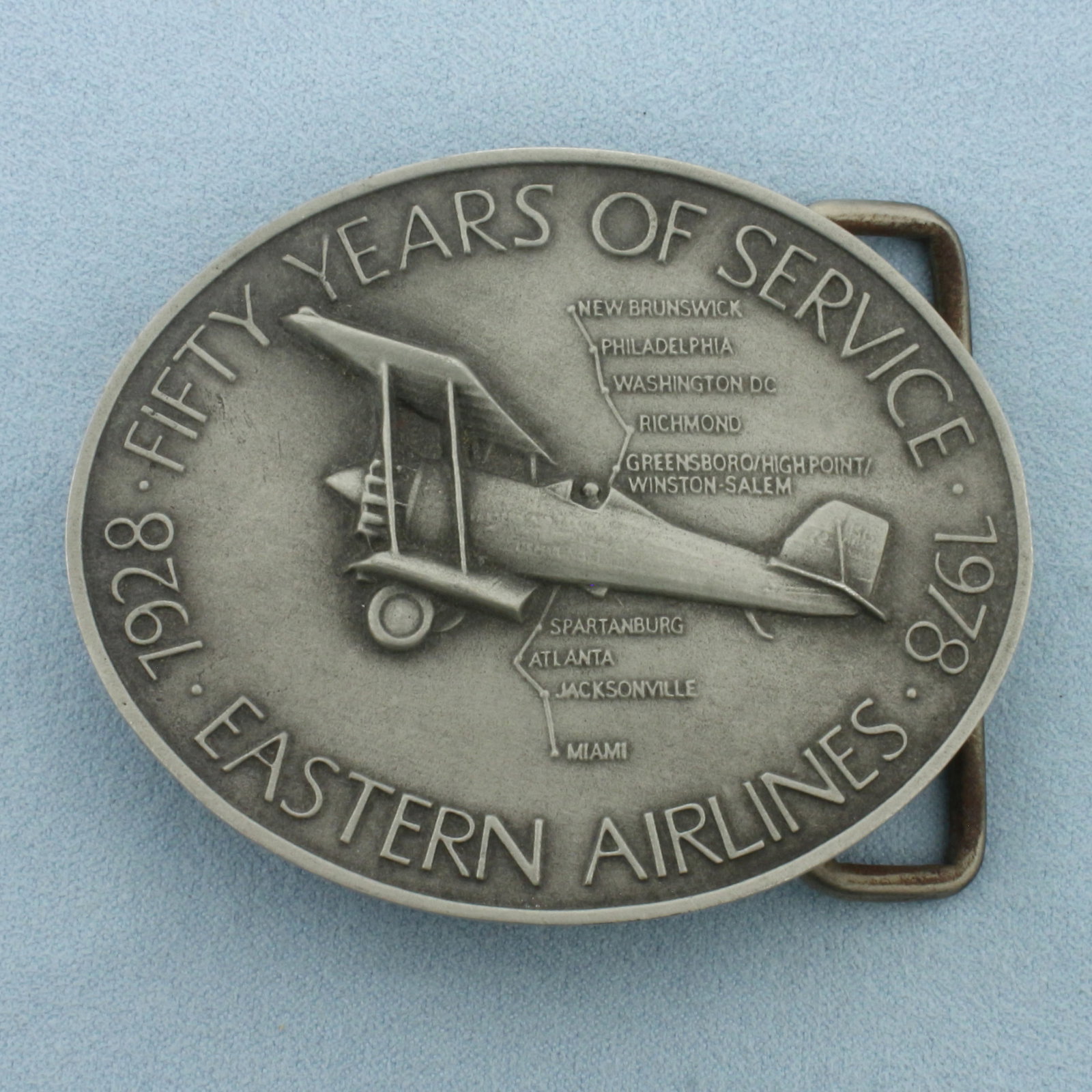Eastern Airlines 50 Years of Service Belt Buckle in Pewter: In Pewter. 3 inches long. 2 3/8 inches wide. 2 inch wide opening.