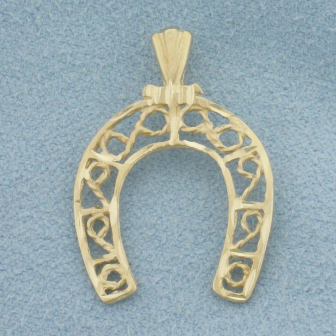 Horseshoe Filigree Pendant in 14k Yellow Gold: In 14k Yellow Gold. 1 inch long (including bale). 5/8 inch wide. 1.2g.