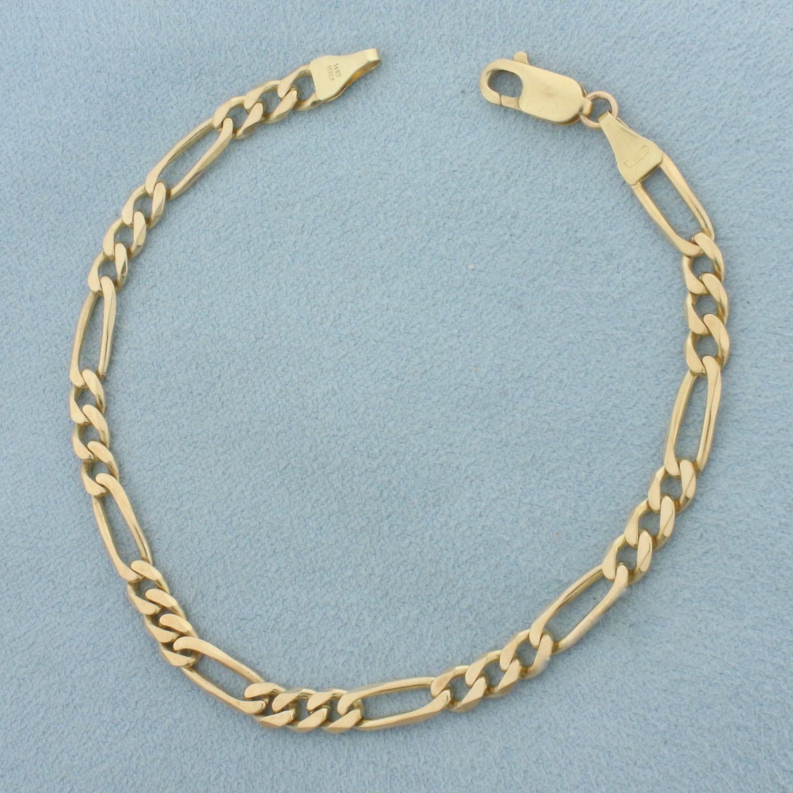 Italian Figaro Link Bracelet in 14k Yellow Gold: In 14k Yellow Gold. 7 3/8 inches long. 4.3mm wide. Italian made. Lobster clasp. 6.2g.