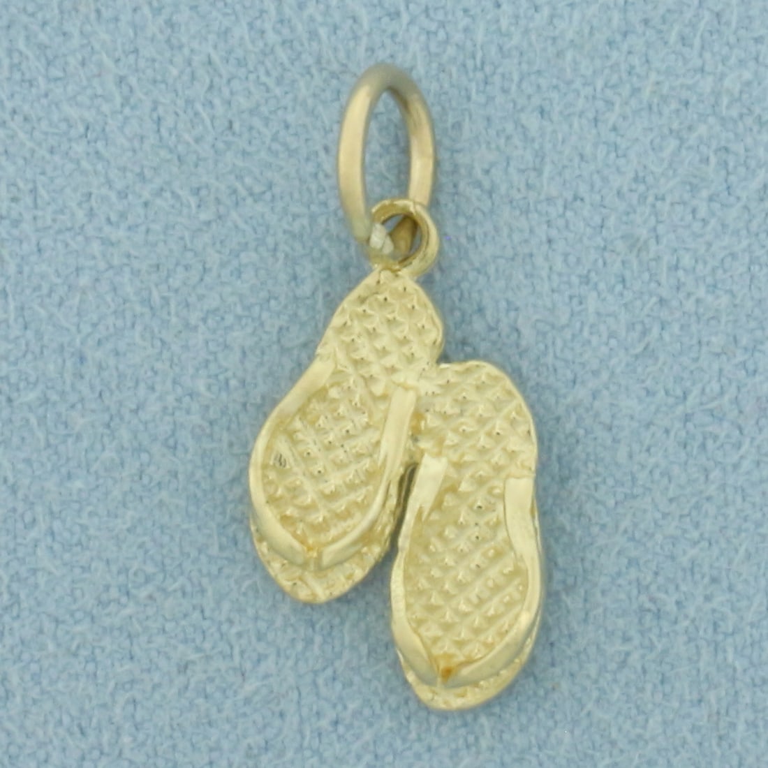 Sanibel Island Flip Flop Charm in 14k Yellow Gold: In 14k Yellow Gold. 5/8 inch long. 3/8 inch wide. 1.2g.