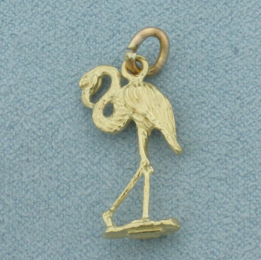 Flamingo Charm in 14k Yellow Gold: In 14k Yellow Gold. 3/4 inch long. 3/8 inch wide. 1.3g.
