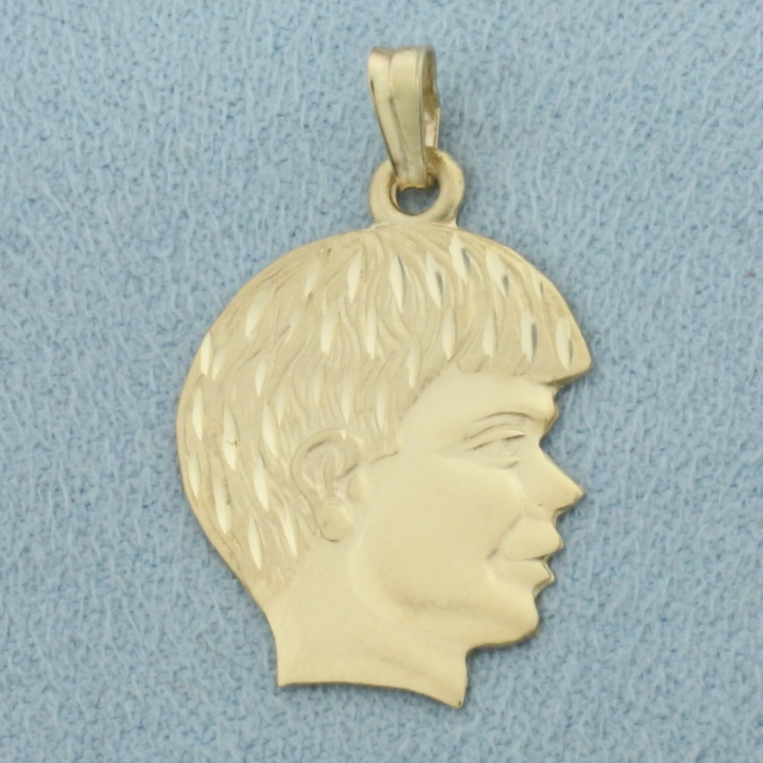 Engravable Boy Silhouette Pendant or Charm in 14k Yellow Gold: In 14k Yellow Gold. 7/8 inch long. 5/8 inch wide. Can engrave name or date on back. 1.5g.