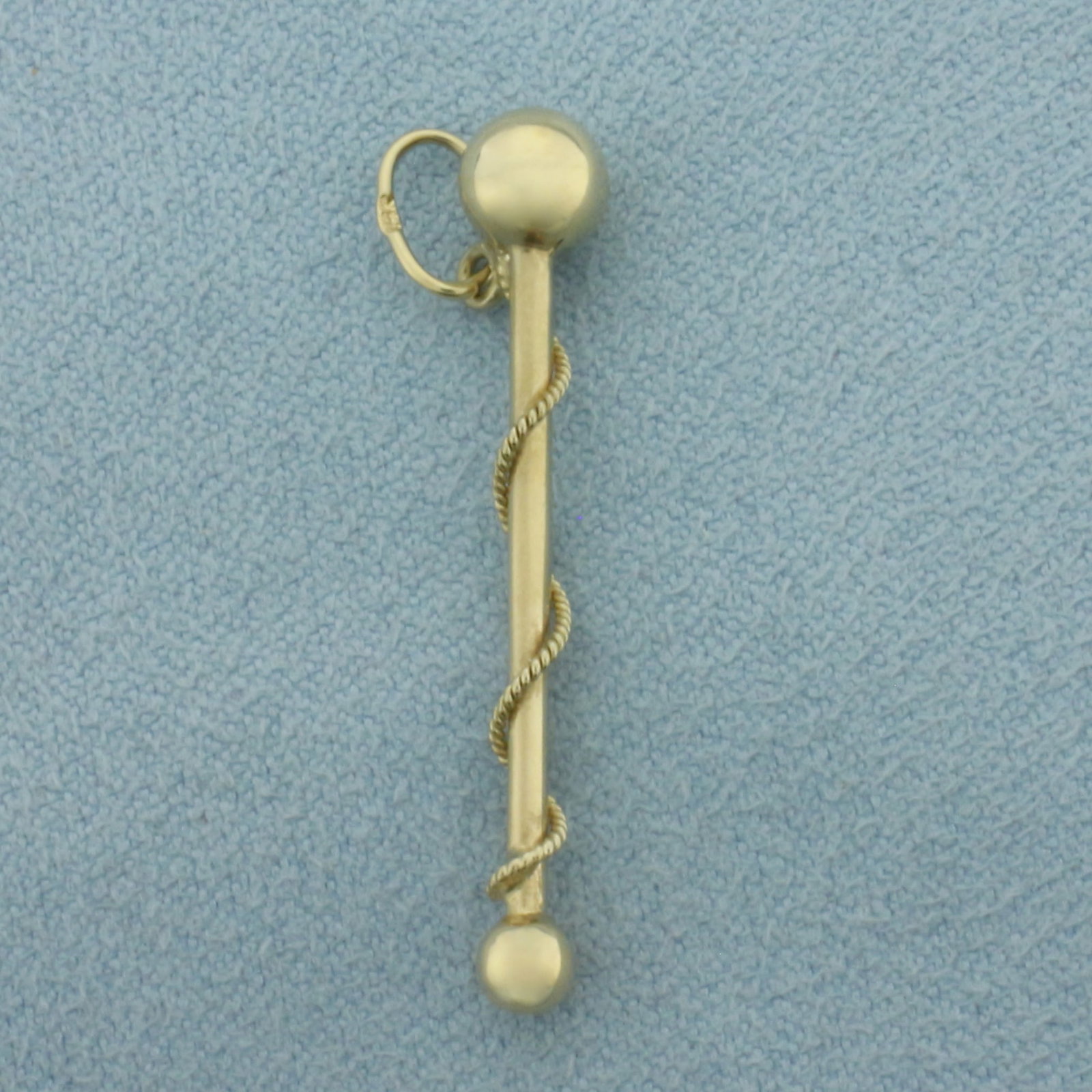 Majorette Baton Charm in 14k Yellow Gold: In 14k Yellow Gold. 1 1/4 inch long. 5.6mm wide at widest point. .8g.