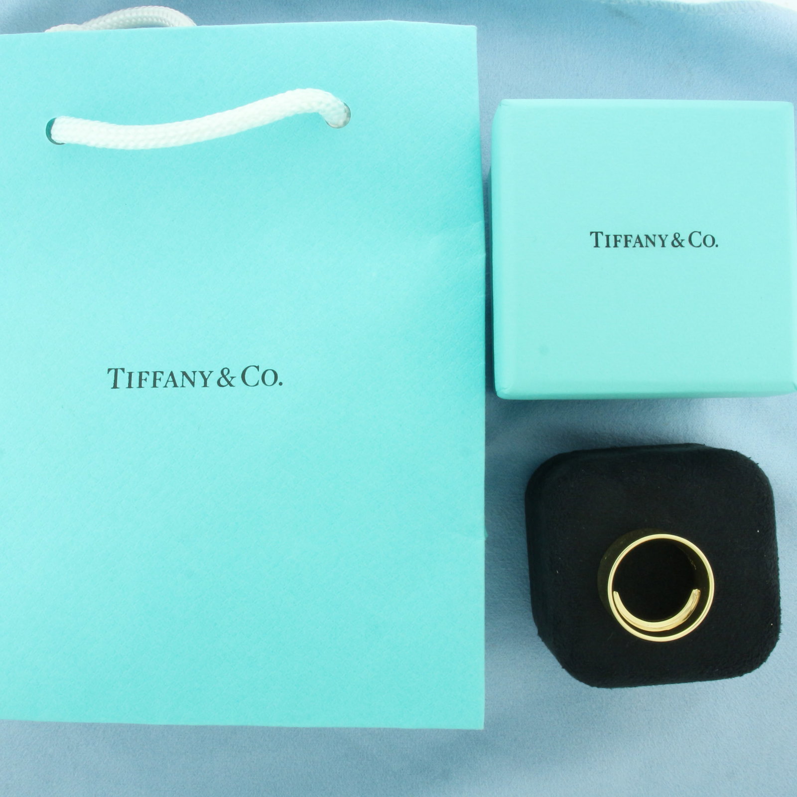 Tiffany & Co. 1837 Curved Wide Cigar Band Ring in 18k Yellow Gold: In 18k yellow gold. Guaranteed authentic. 12mm wide. Comes with Tiffany Box and bag as shown. Engraved inside, can be removed. Size 5.25. 11.9g