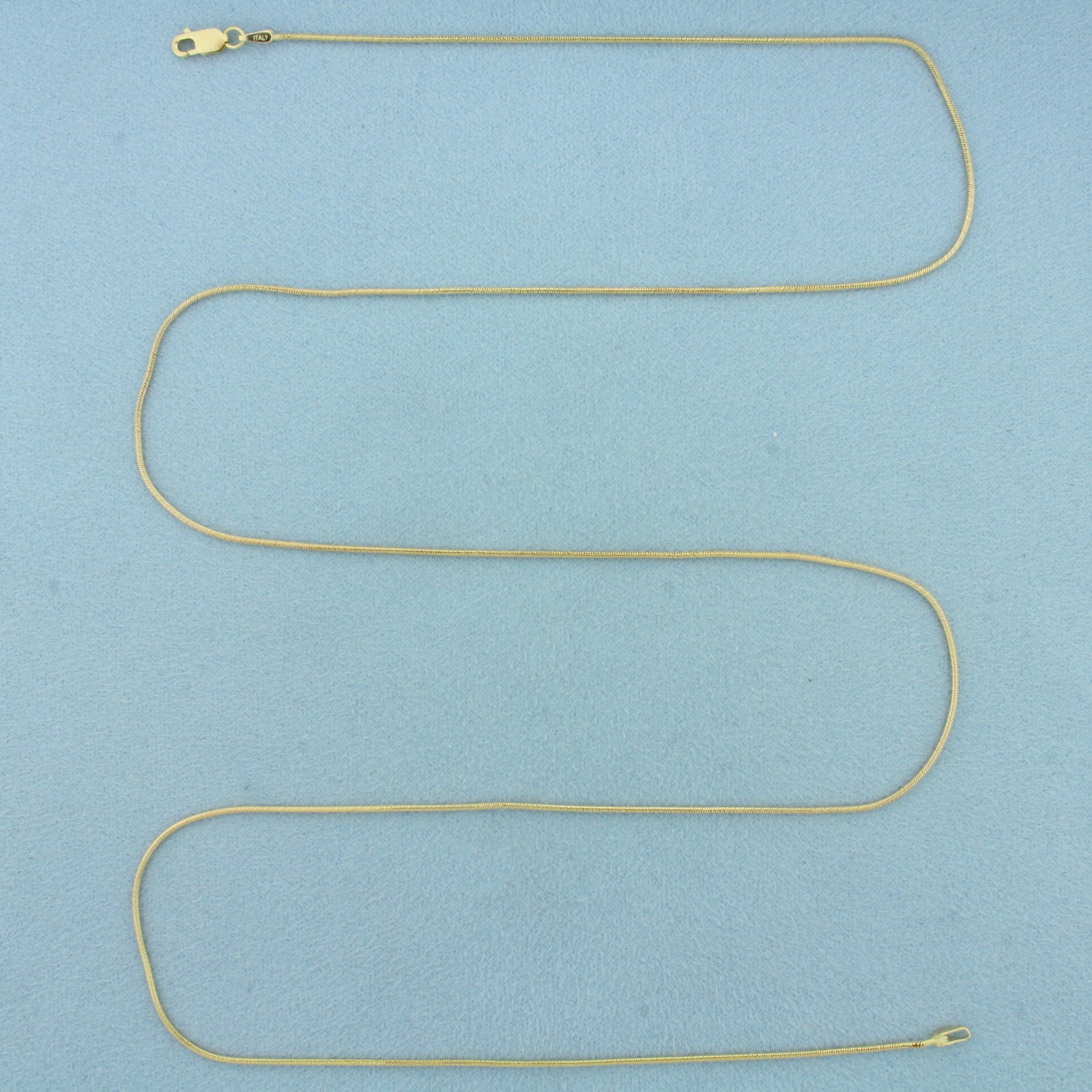 26 Inch Italian Snake Link Chain Necklace in 14k Yellow Gold: In 14k Yellow Gold. 26 inches long. 0.9mm wide. Italian made. Lobster clasp. 4.7g.