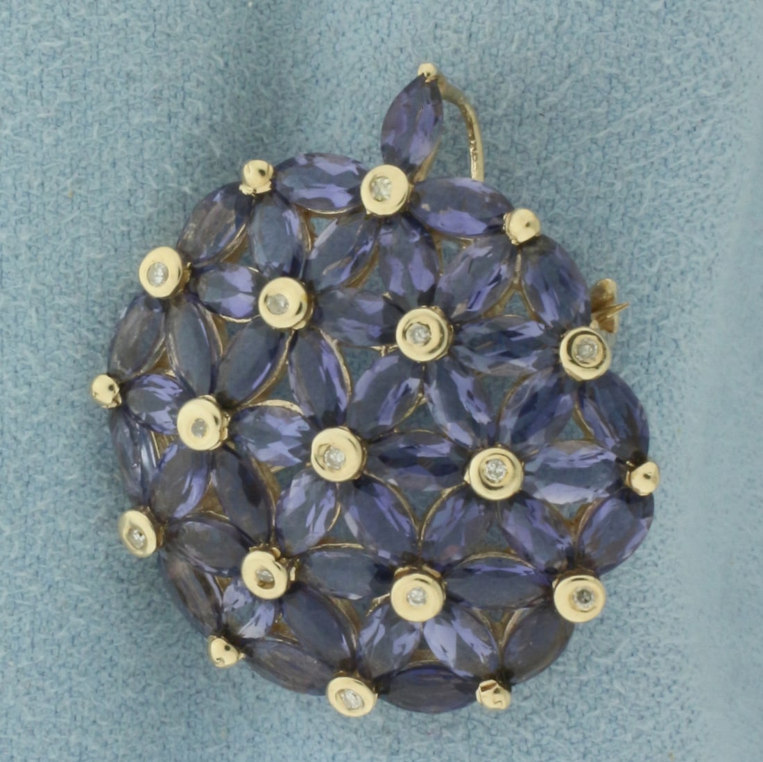 Tanzanite and Diamond Pendant or Brooch in 10K Yellow Gold: In 10k yellow gold. 1 1/8 inch long by 1 inch wide. Contains 43 marquise cut Tanzanite, 5x2.5mm each, with intense color and excellent clarity. Also contains 13 high quality .01ct diamonds. Can be