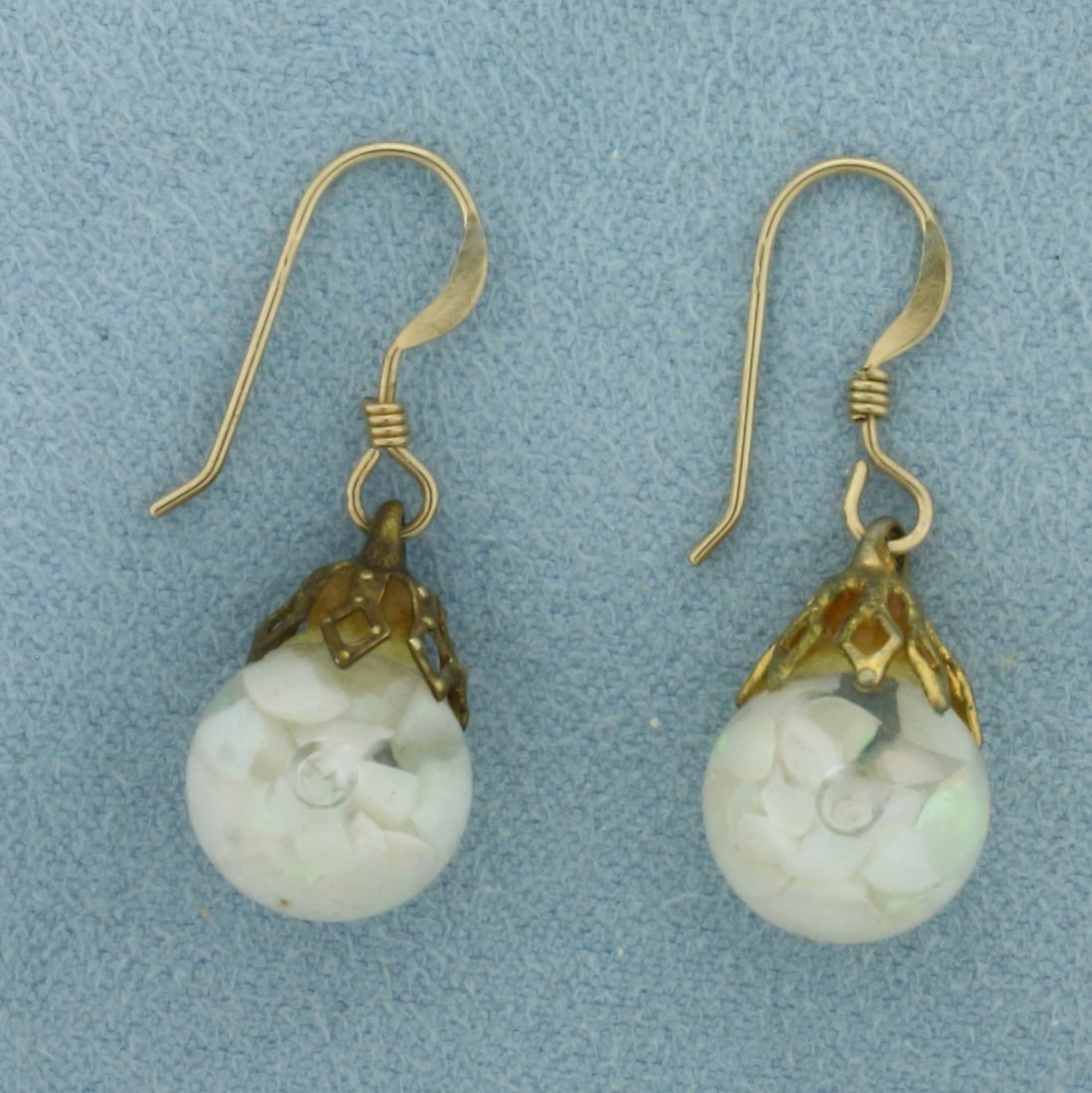 Vintage Floating Dangle Opal Earrings: 14k gold plated. 1 inch long by 3/8 inch wide. Flecks of opal gems suspended in liquid inside globes. Hook backs. 2.4g.