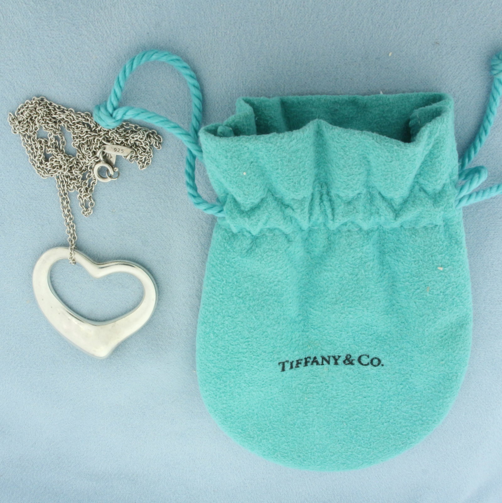 Tiffany and Co. Large Open Heart Pendant on Chain in Sterling Silver: Designer signed Tiffay & Co. In .925 sterling silver. Chain is 30 inches long. Pendant is 36mm. Original pouch included. 20.1g.