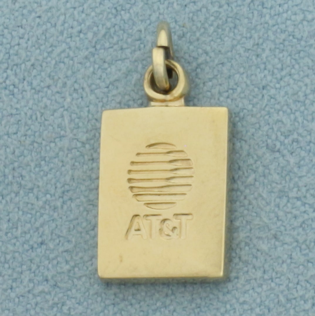Vintage AT&T Charm in 14k Yellow Gold: In 14k Yellow Gold. 5/8 inch long. 3/8 inch wide. 2.8g.