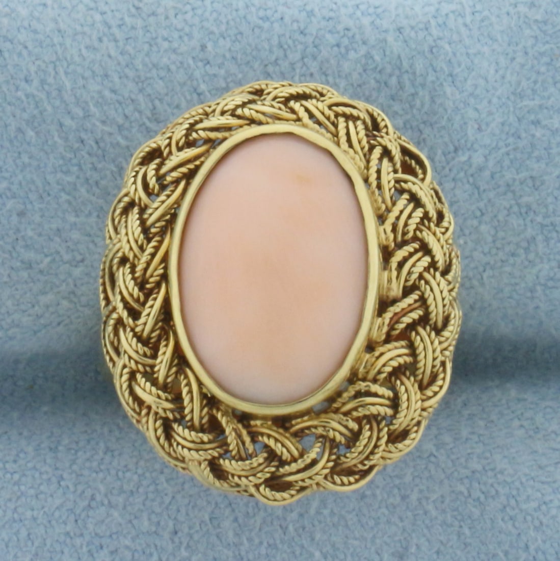 Angel Skin Pink Coral Ring in 18k Yellow Gold: In 18k Yellow Gold. Contains one 13x9mm high quality oval cabochon angel skin Coral gemstone with beautiful pink color. 21mm wide at top of ring. Size 5.25. 6.1g.