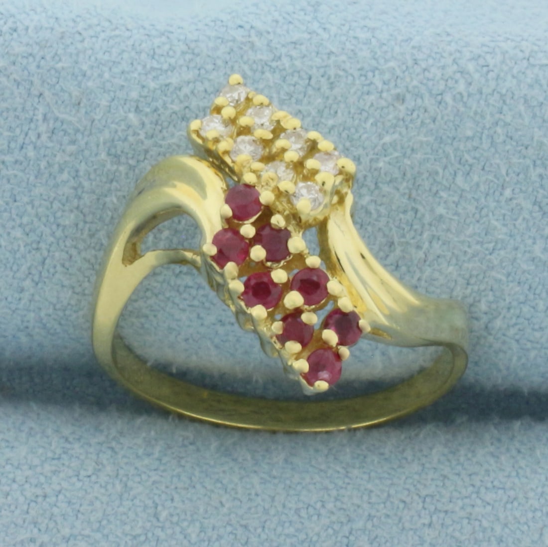 Ruby and Diamond Bypass Ring in 18k Yellow Gold: In 18k Yellow Gold. Contains eight 2mm high quality natural Ruby gemstones with vibrant color. Also contains eight .02ct high quality diamonds, SI clarity/G color. 18mm wide spread at top of ring. Siz