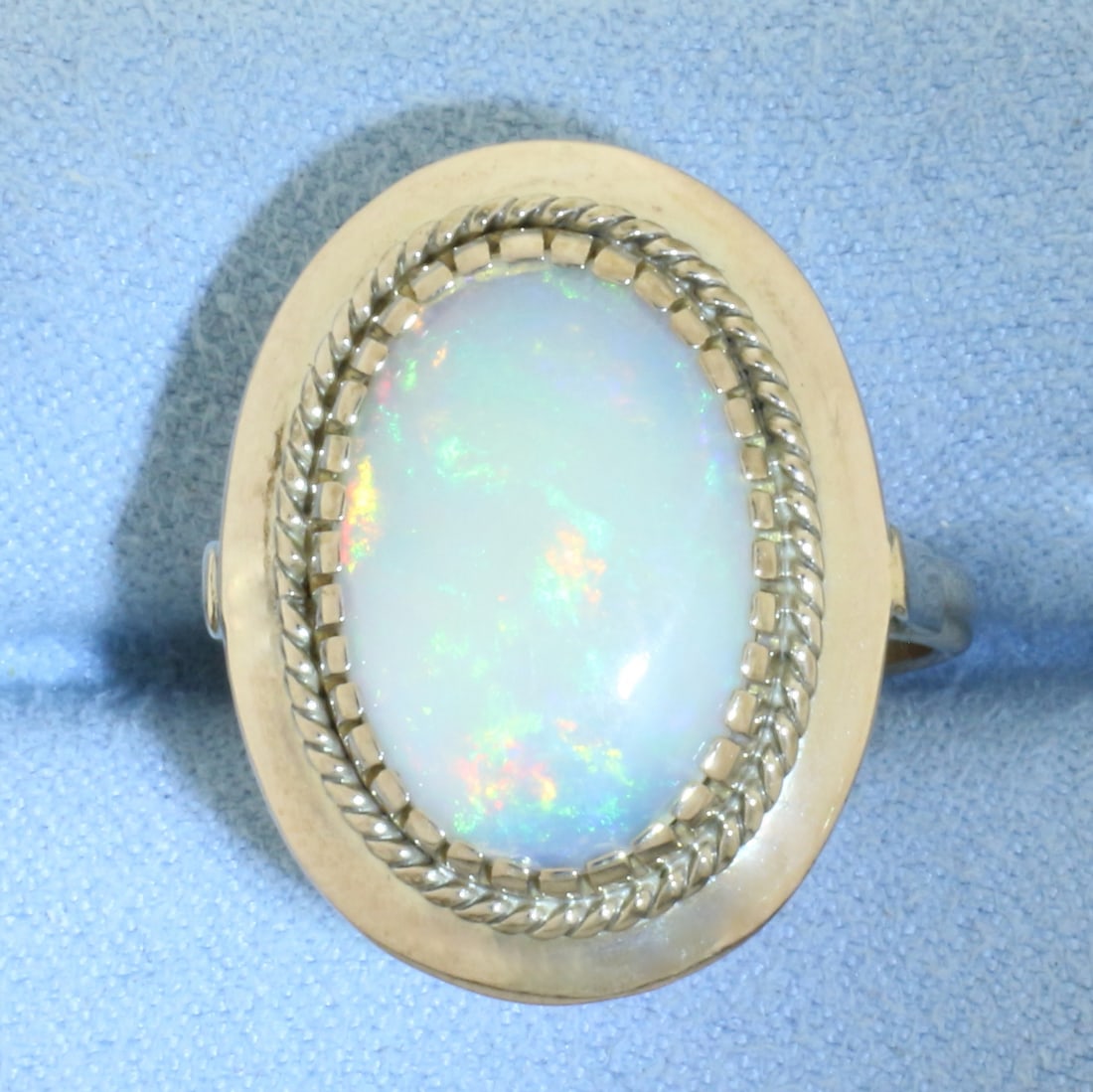 Vintage Opal Ring in 14K Yellow Gold: In 14k yellow gold. Contains 1 high quality natural 17x12mm Opal gemstone with excellent play of color, flashes of red, orange, blue, and green. Size 8.5.
