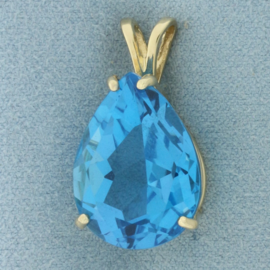Swiss Blue Topaz Pear Pendant in 14K Yellow Gold: In 14k yellow gold. 1 inch long by 5/8 inch wide. Contains one high quality natural pear cut Swiss Blue Topaz gemstone, 20mm x 15mm, approximately 20ct, with intense electric blue color and excellent 