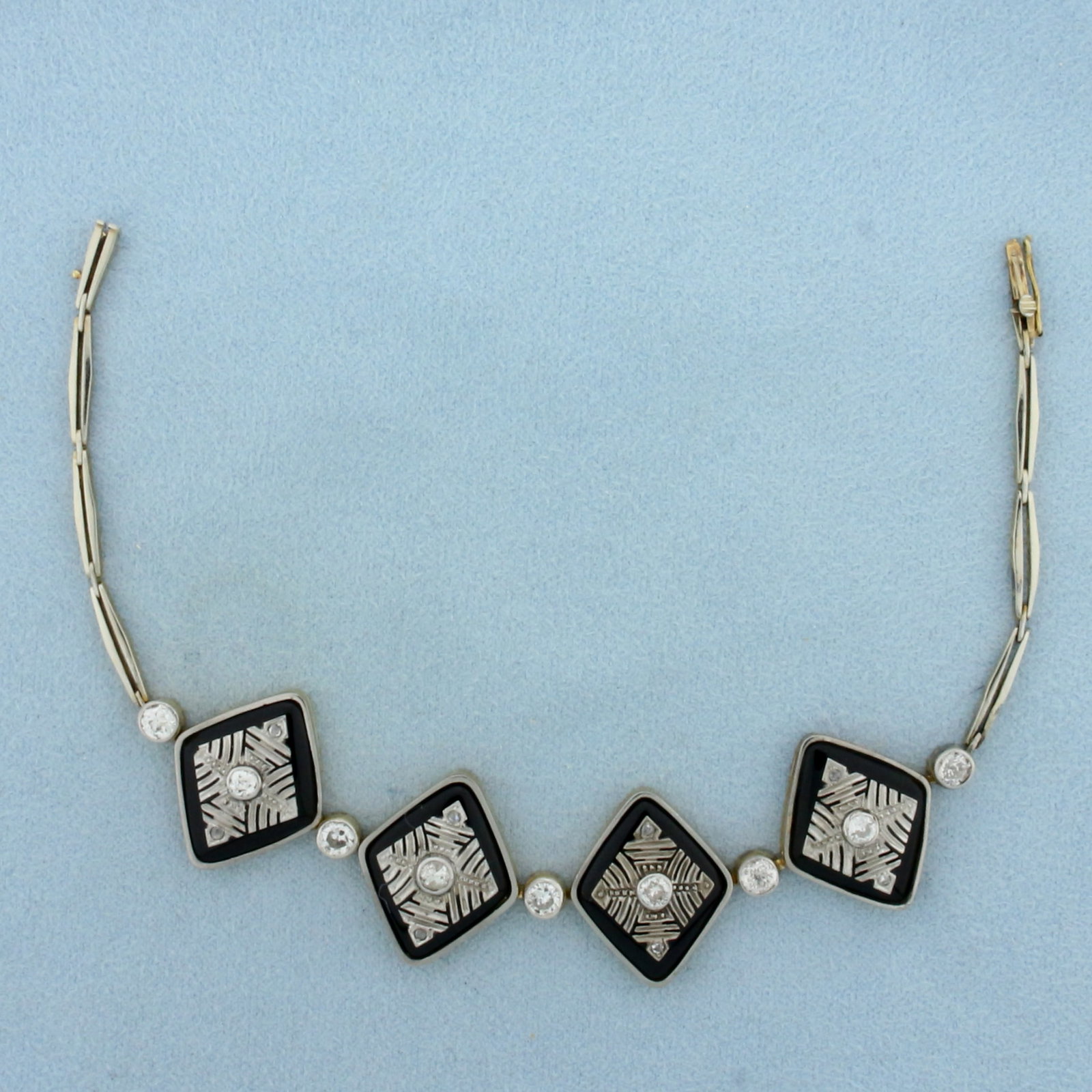 Antique Old Mine Cut Diamond and Onyx Bracelet in 18k Yellow and White Gold: In 18k yellow and white gold. 7 3/8 inches long by 3/4 inches wide (at widest). Contains five high quality 1/4ct Old European cut diamonds, SI clarity/H color. Also contains 4 Old Mine Cut and 8 Rose