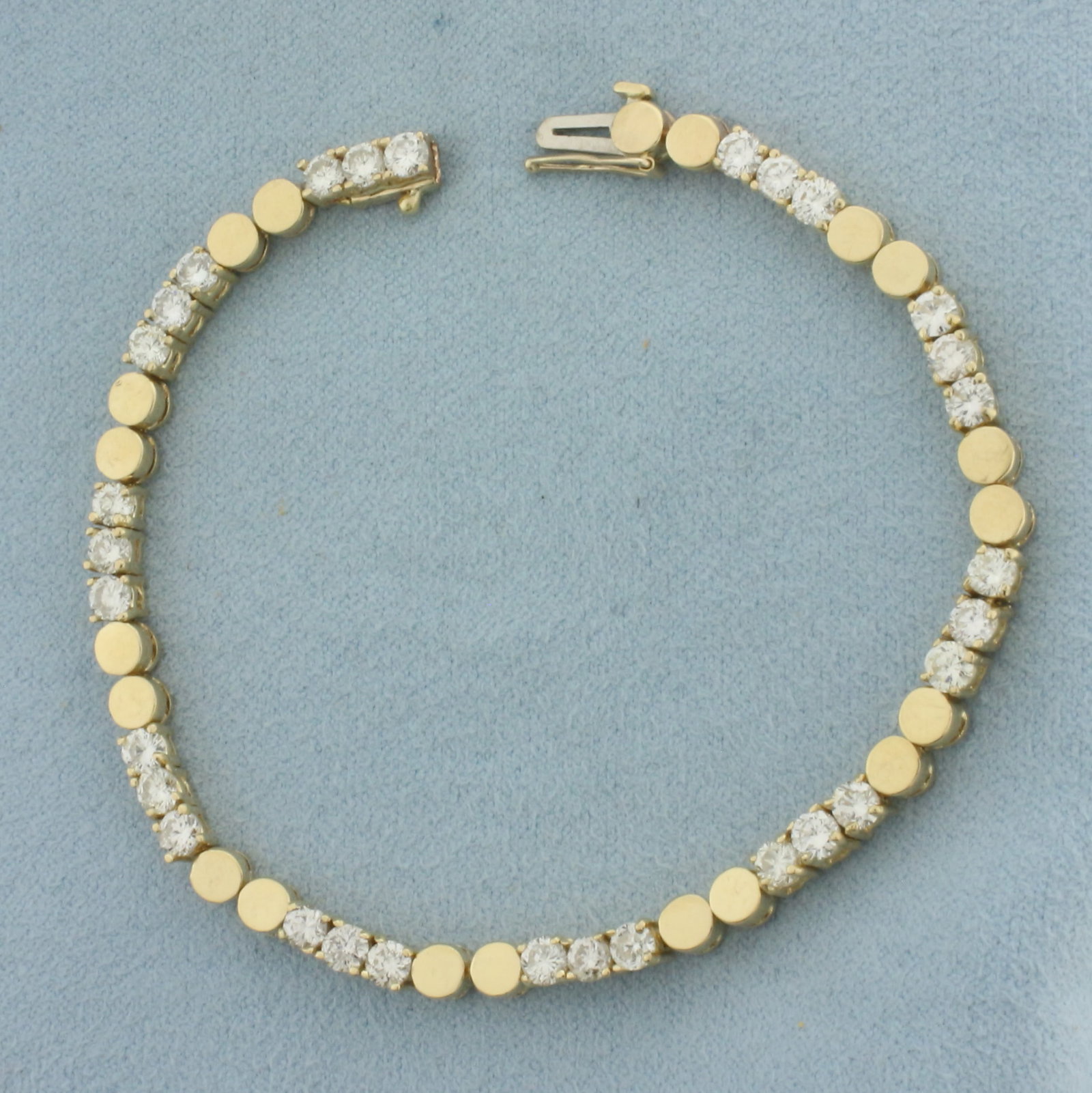 Diamond Tennis Bracelet in 14K Yellow Gold: In 14k yellow gold. 7 inches long by 3.8mm wide. Contains 30 high quality 1/8ct diamonds, 3.75ct TW, SI clarity/H color. Concealed slide clasp with safety latch. 11.5g.