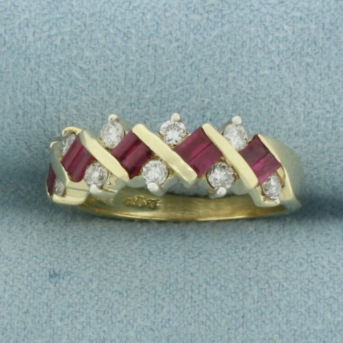 Ruby and Diamond Ring in 14K Yellow Gold: In 14k yellow gold. 6.7mm wide at top of ring. Contains 10 high quality 3x2mm natural emerald cut natural Rubies with intense color and excellent clarity. Also contains 10 high quality .05ct diamonds.