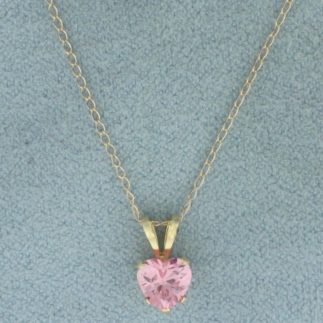Heart Cut Pink Topaz Necklace in 14K Yellow Gold: In 14k yellow gold. Chain is 18 inches long and 1mm wide, spring clasp. Contains 1 high quality heart shaped Pink Topaz gemstones, 5.2mm, with bright pink color and excellent clarity. .8g.