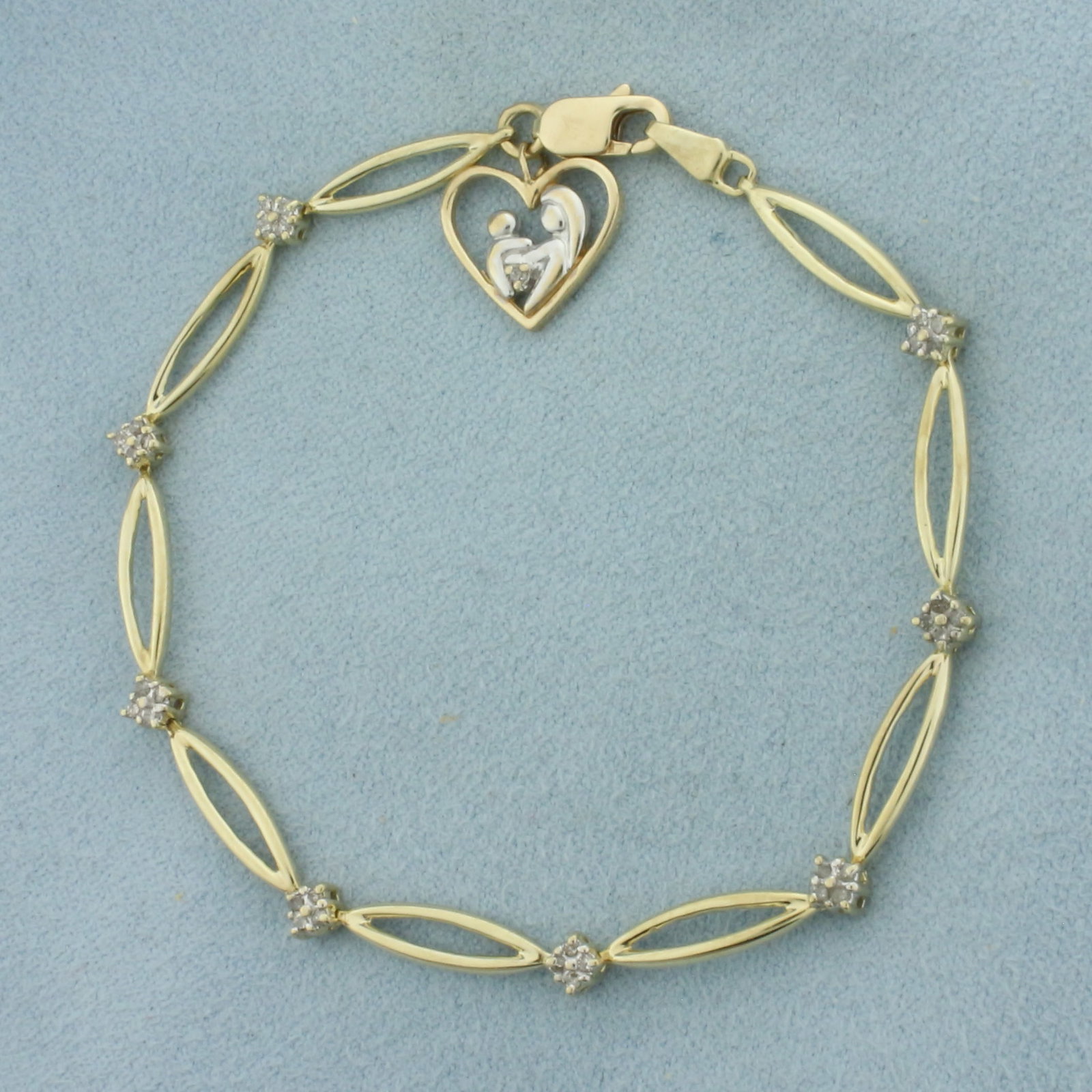 Mother and Child Diamond Bracelet in 10K Yellow Gold: In 10k yellow gold. 7 1/8 inch long by 1/8 inch wide. Contains 32 high quality 1/2pt diamonds. Lobster clasp. 4.7g.