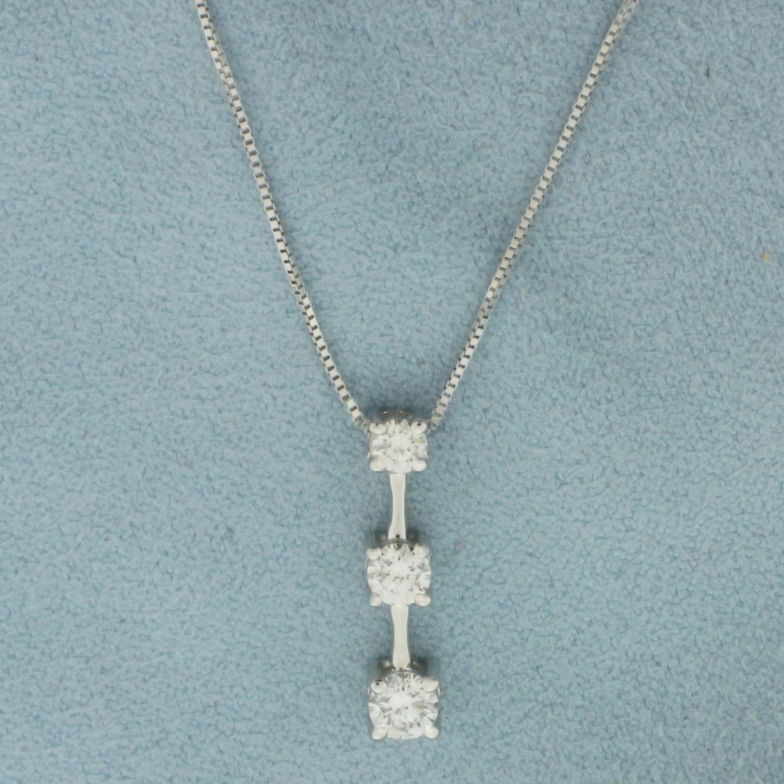 3 Stone Past Present and Future Diamond Necklace in 14K White Gold: In 14k white gold. Pendant is 3/4 inch long and contains 3 diamonds: .20ct, .15ct, .12ct. 1/2 ct TW, SI clarity/G color. Box link chain is 18 inches long by .6mm wide, lobster clasp. 2.7g.