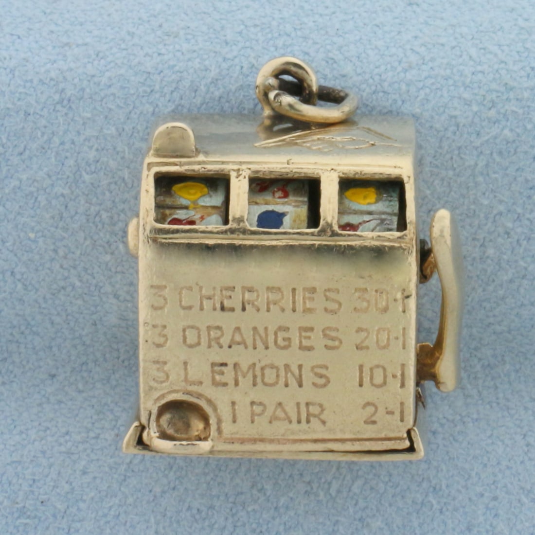 Vintage Mechanical Fruit Slot Machine Charm in 14k Yellow Gold: In 14k Yellow Gold. Can pull lever and reels spin. 7/8 inch long. 3/4 inch wide. Enamel details. 20.5g.