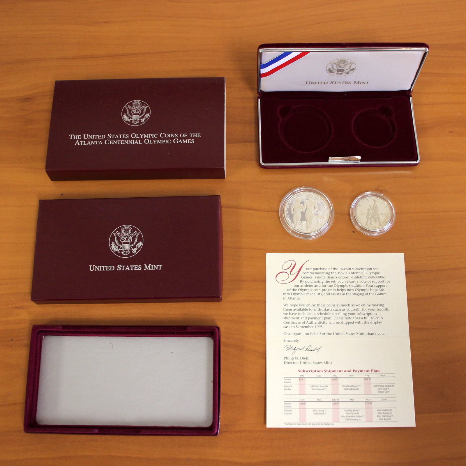 US Mint Atlanta Centennial Silver Olympic Two Coin Proof Set OGP: Contains one 1995 or 1996 U.S. Mint Atlanta Centennial 90% Silver Olympic Games 2-Coin Set. Includes original box and packaging.