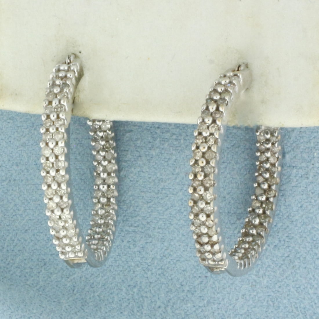 Diamond Inside Out Hoop Earrings in 10K White Gold: In 10k white gold. Contains seventy-two high quality natural diamonds, 3/4ct TW, SI clarity/I color. Measures 1 inch diameter. Leverbacks. 5.1g.
