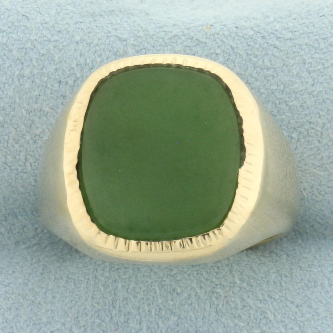 Mens Bezel Set Jade Ring in 10k Yellow Gold: In 10k yellow gold. Contains one high 15mm by 13mm high quality jade gemstone with uniform color and excellent clarity. 19mm wide at widest point. Size: 10.25. 11.3g.