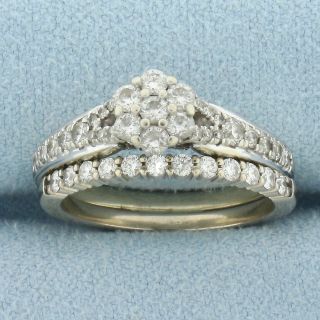 Diamond Flower Design Engagement and Wedding Ring Bridal Set in 10k White Gold: In 10k White Gold. Contains 65 high quality diamonds, 1ct TW, I color/I clarity. Engagement and Wedding ring are soldered together. Size 6. 5.4g.