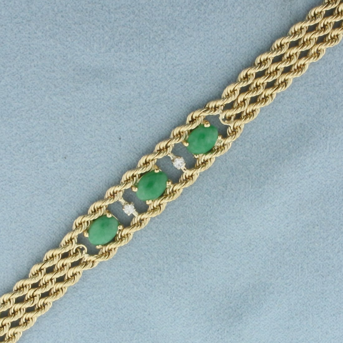 Jade and Diamond Triple Rope Bracelet in 14k Yellow Gold: In 14k Yellow Gold. 7 1/8 inches long. 3/8 inch wide. Contains 3 high quality natural 7mm Jade gemstones with vibrant color. Also contains 2 high quality .04ct diamonds, VS clarity/G color. Concealed 