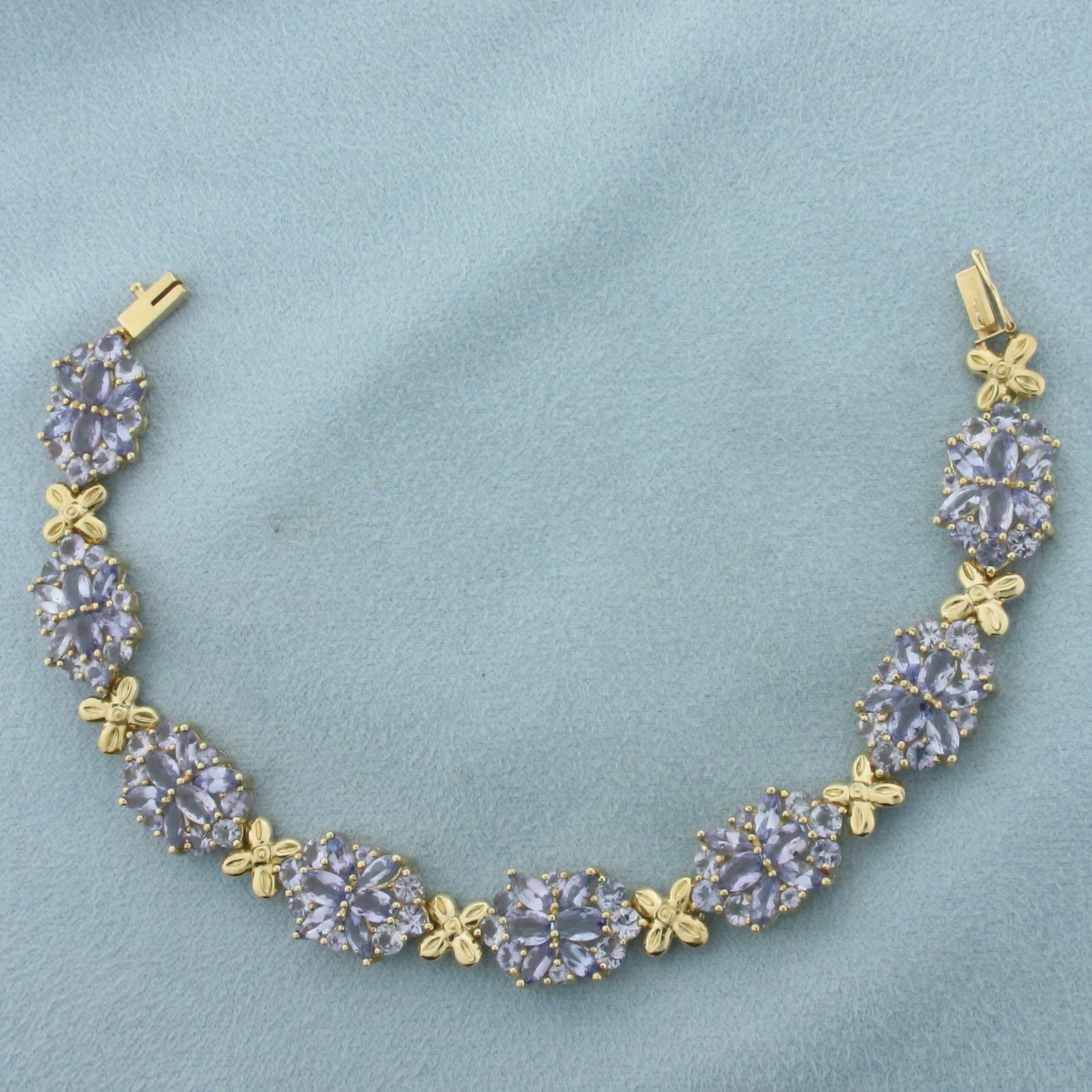 8ct Tanzanite Bracelet in 10K Yellow Gold: In 10k yellow gold. 7 1/4 inches long, 3/8 inches wide. Contains sixteen oval cut 3x5mm, thirty-two marquise cut 2.5x5mm, forty-eight round cut 3mm, and sixteen round cut 2mm high quality natural Tanz
