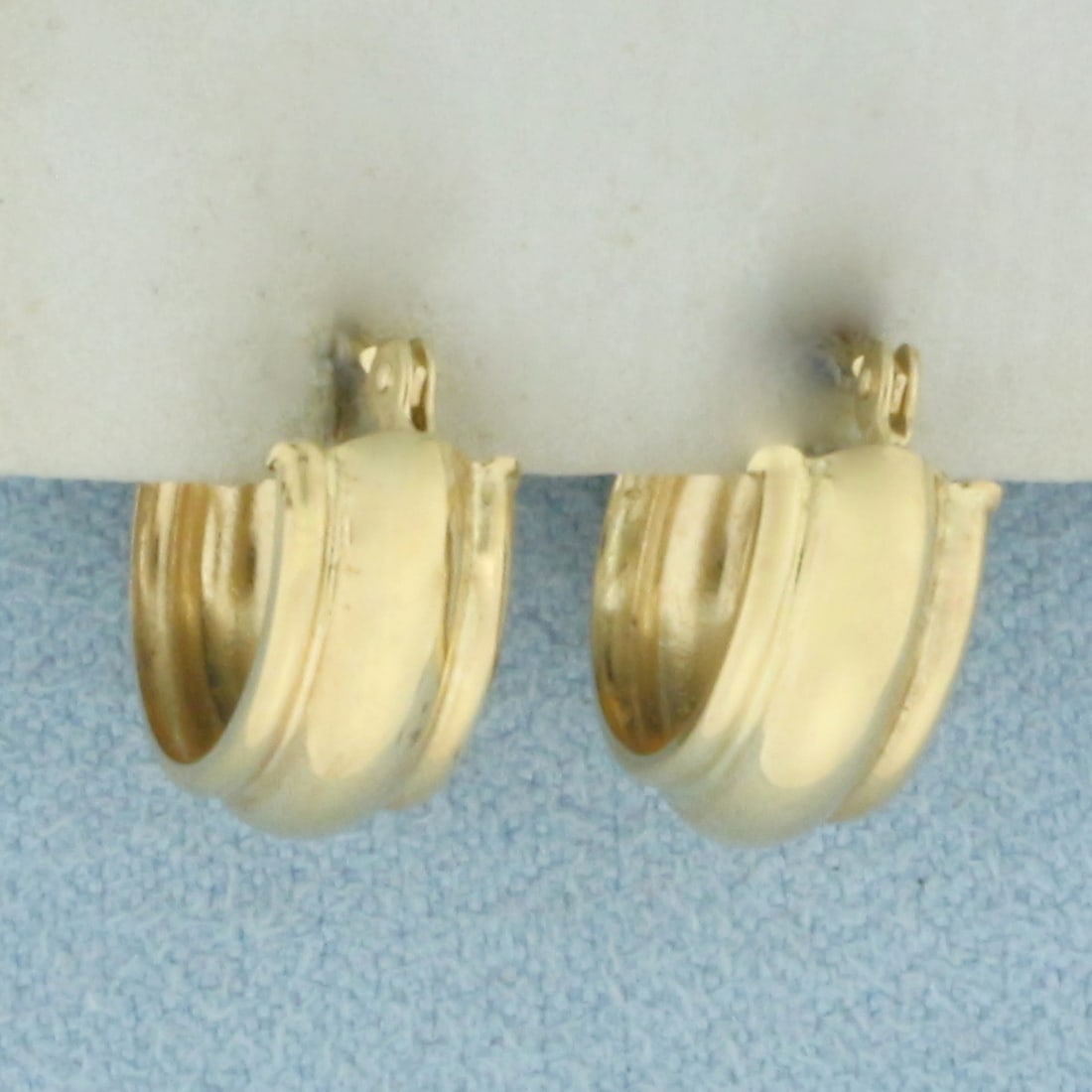 Huggie Hoop Earrings in 14k Yellow Gold: In 14k Yellow Gold. 1/2 inch long. 1/2 inch diameter. 5.4mm wide. .9g.