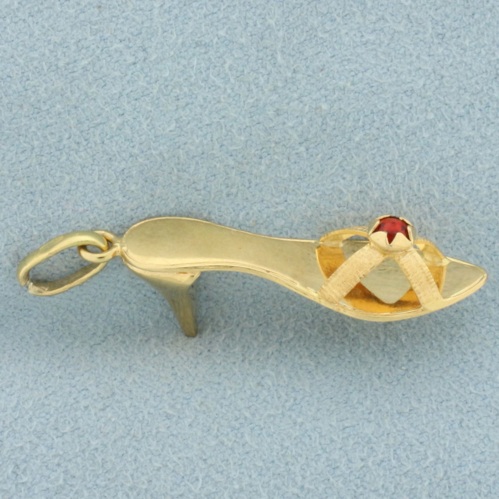Ruby High Heel Shoe Charm or Pendant in 18k Yellow Gold: In 18k yellow gold. Contains one high quality 3mm Ruby gemstone with vibrant color. 1 3/8 inches long, 3/8 inch wide. 3.2g.