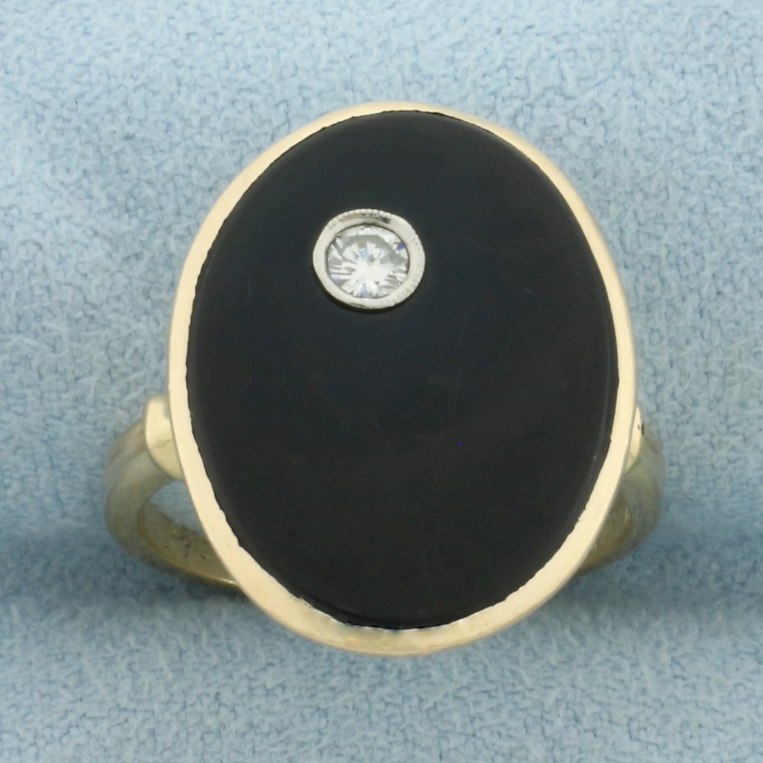Onyx and Diamond Ring in 14k Yellow Gold: In 14k Yellow Gold. Contains one .08ct high quality diamond, VS clarity/G color. 19x15mm high quality oval Onyx plaque. 20.4mm wide at center of ring. Size 6.75.
