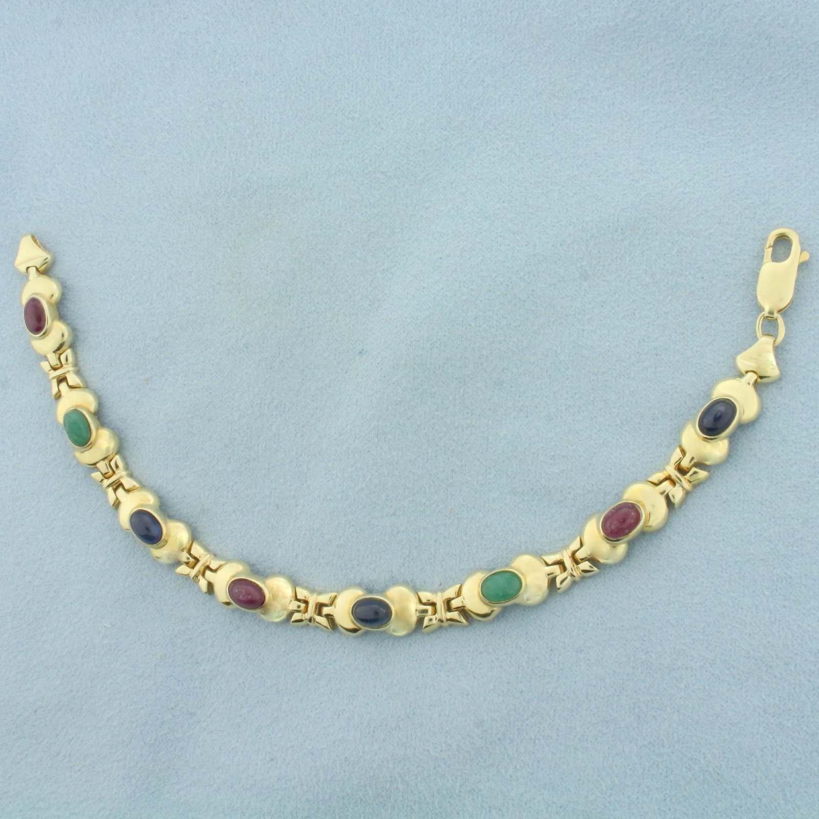 Sapphire Ruby and Emerald Bracelet in 14K Yellow Gold: In 14k yellow gold. 7 inches long by 7.5mm wide. Contains cabochon cut 4mmx6mm high quality natural gemstones as follows: 3-sapphires, 3-rubies, and 2-emeralds, all with intense color and excellent cl