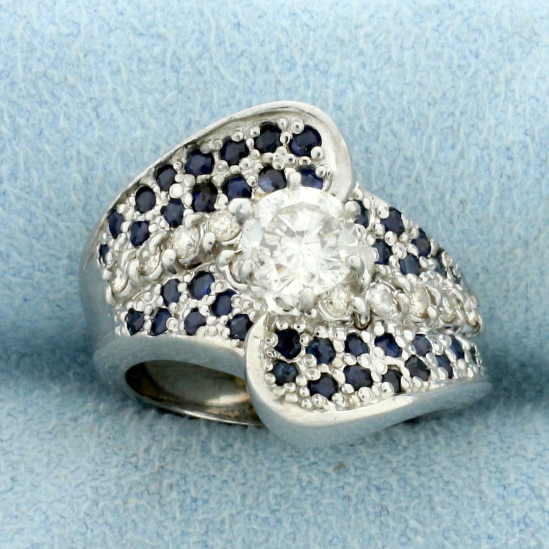 Vintage Natural Sapphire and Diamond Engagement Ring in 14k White Gold: In 14k White Gold. Center diamond is a .55ct round brilliant, H color/I clarity. Also contains twelve high quality .02ct round Diamonds of similar high quality. Also Contains forty one high quality na