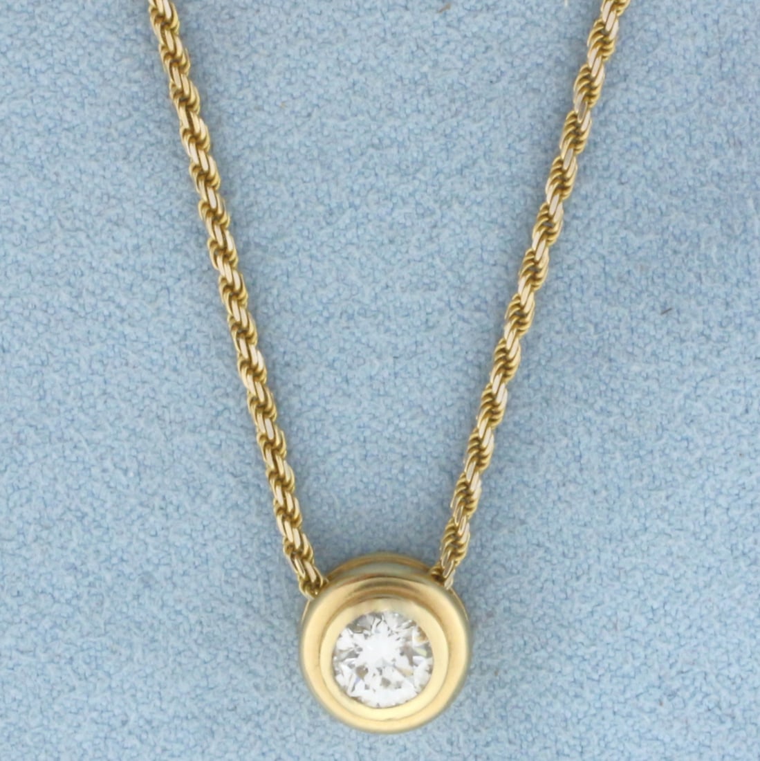 18 Inch Bezel Set Solitaire Diamond Necklace in 14k Yellow Gold: In 14k yellow gold. Contains one .6ct round brilliant diamond, VS clarity/G color, great cut for lots of sparkle. Chain is 18 inches long, 1.4mm thick rope link chain. Spring clasp. 5.6g.