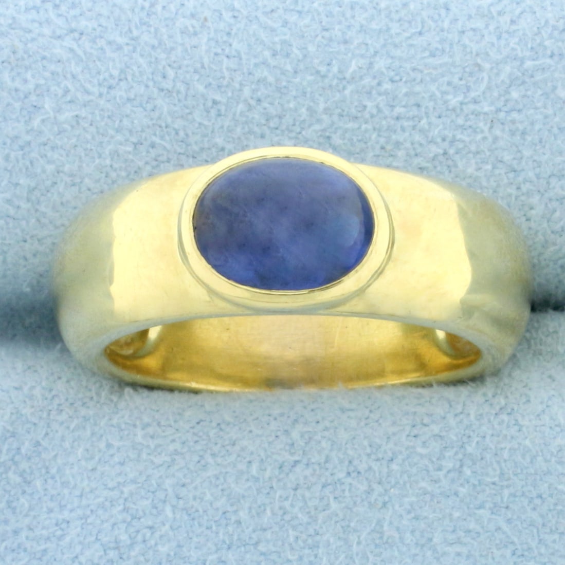 Mens Solitaire Sapphire Ring in 18k Yellow Gold: In 18k yellow gold. Contains one cabochon 9x7mm high quality natural Sapphire gemstone, approximately 3ct, with vibrant blue color. Size 9 1/2. 12.1g.