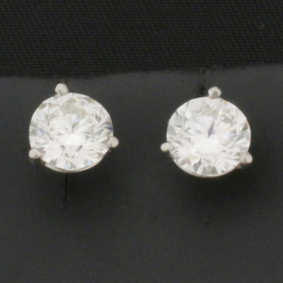 2ct GIA Certified Diamond Stud Earrings in Platinum Settings: In platinum martini settings. Contains two 1ct GIA certified round brilliant diamonds. Excellent cut. J color, SI2 clarity, eye clean, diamonds face up very white. Friction backs.